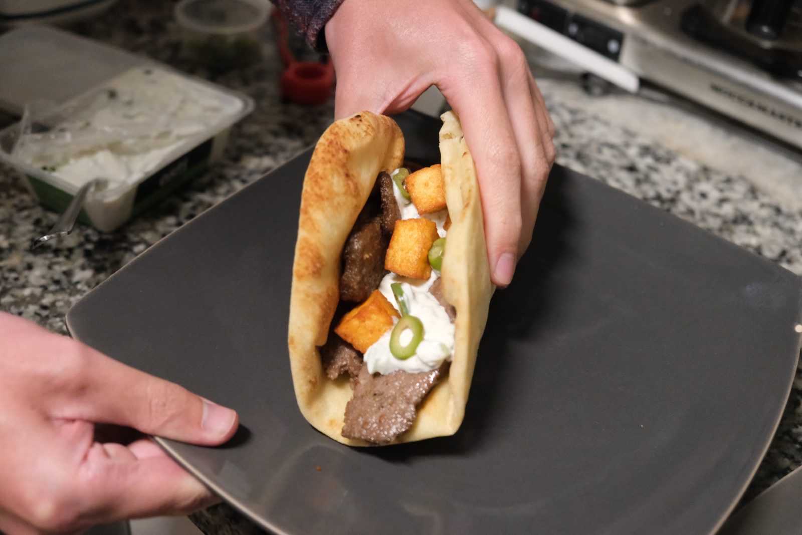 Lamb gyro served with tzatziki, fried halloumi bites and olives on naan. 